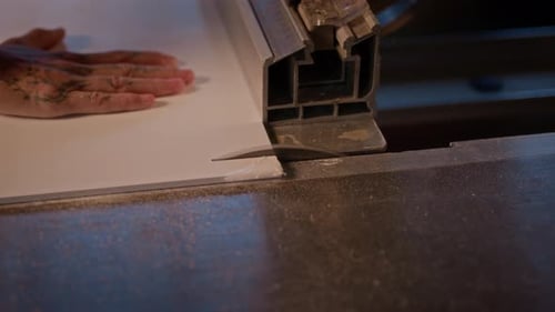 Carpenter Working On Machine In Workshop