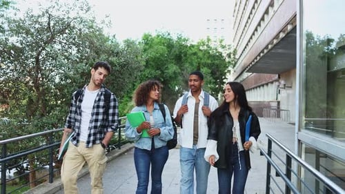 Diverse students walking and chatting on campus, enjoying conversation