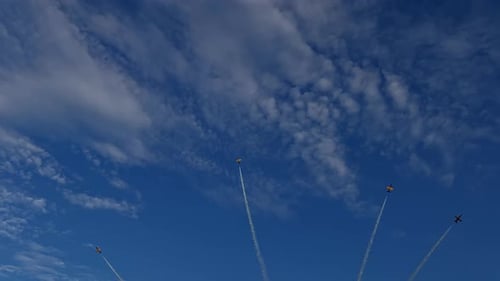 Aerobatic Planes Flying in Formation on Sunny Day