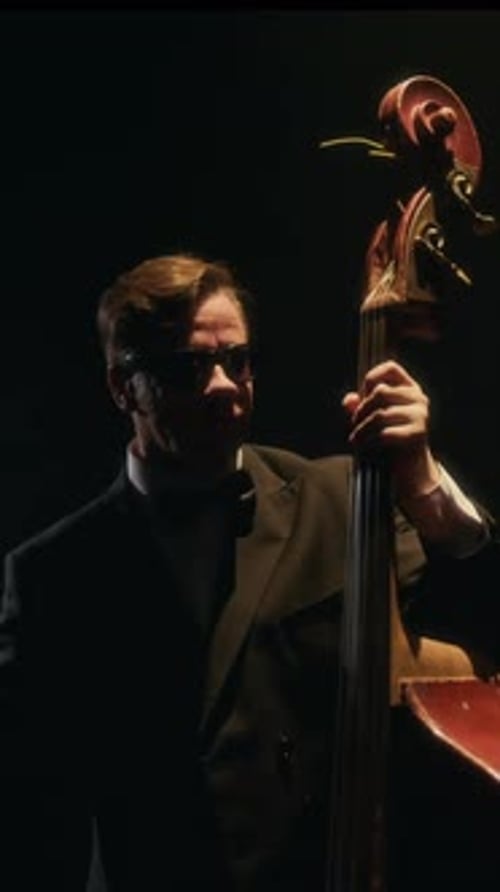 Man in Suit Plays Double Bass at Night