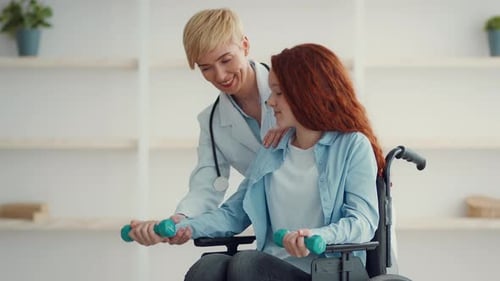 Woman in Wheelchair Working Out With Doctor