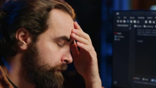 Man Working Late in Front of Computer Monitor