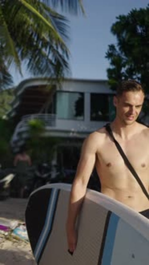 Young Adults Paddleboarding at Tropical Beach