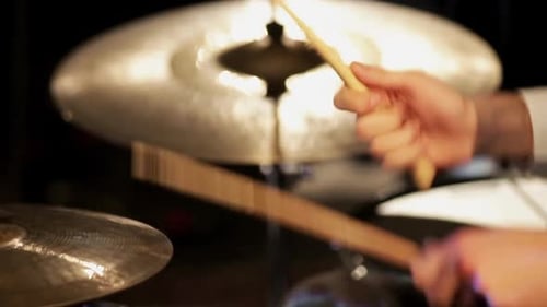 Drummer Playing Cymbal While Performing at Concert
