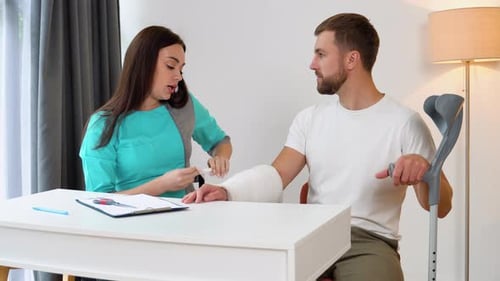 Doctor Wraps Man's Arm After Cast Removal