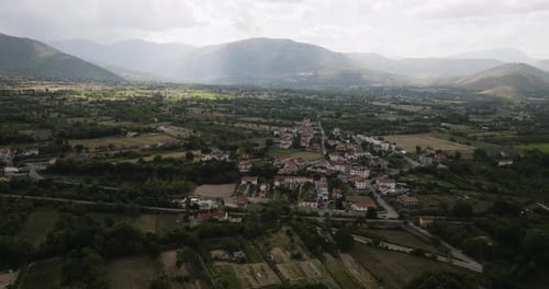 Aerial view of a town surrounded by mountains, Italy.