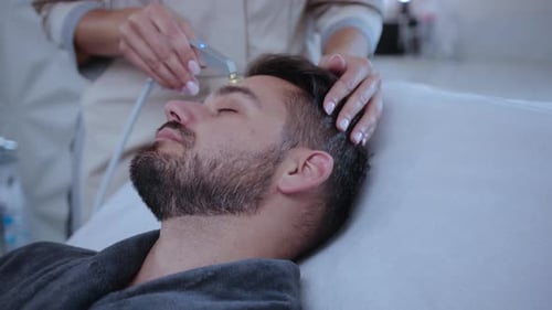 A Man Enjoying a Rejuvenating Facial Treatment at a Luxurious Spa for Relaxation and Beauty