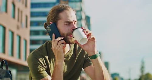 Man Talking on Phone with Coffee Outdoors