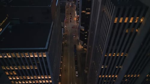 Aerial View of Cars Between City Skyscrapers at Night