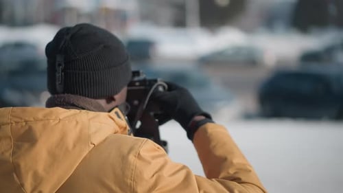 Man Taking Photographs with Vintage Camera Outdoors