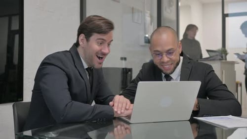 Excited Business People Celebrating Success in Office