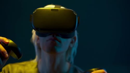 Woman Uses VR Headset in Dark Lit Room
