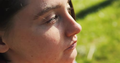 Beautiful Girl Eats Fast Food Take Out in the Park Woman Enjoys Street Food Burger in Sunlight