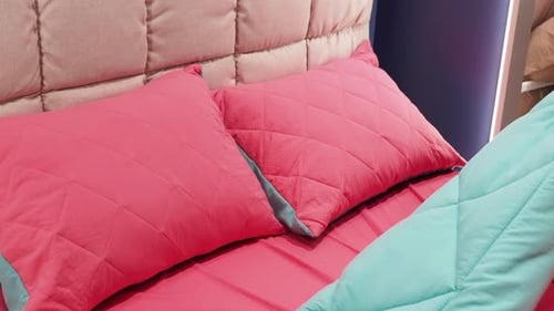 Comfortable Bed with Pillows and Quilted Blanket