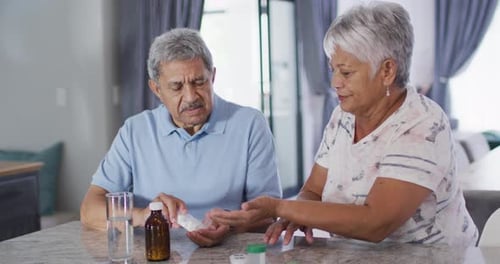 Senior Couple Manage Pills at Home Together