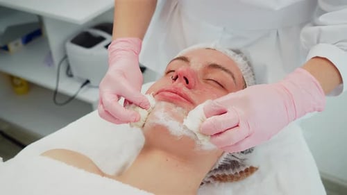 Cosmetologist Wiping Client Face During Skincare Session Professional Removing Mask with Smooth