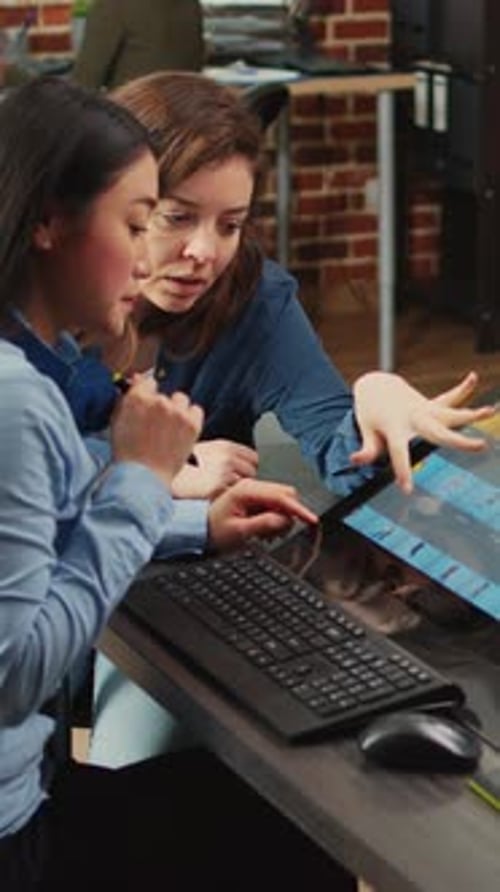 Women Collaborating on Touch Screen in Modern Office