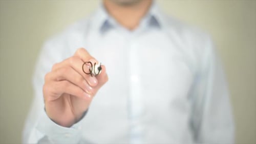 Person Writing Qualification on Transparent Surface
