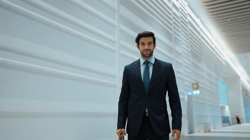 Smiling Businessman Standing in Modern Hallway