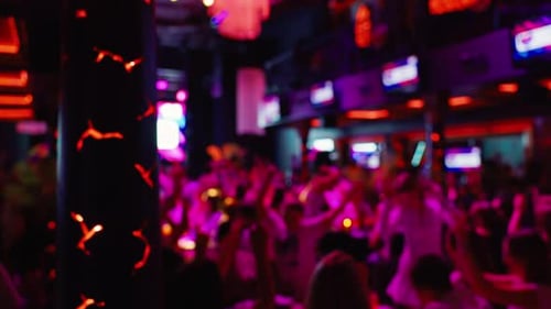 Energetic Crowd Dancing in a Vibrant Urban Nightclub