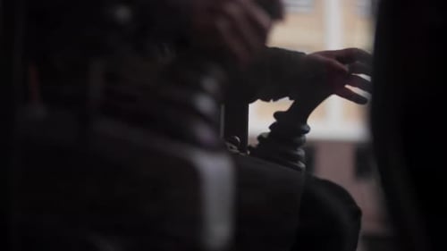 Excavator Operator Controlling Hydraulic Joystick Inside Cabin