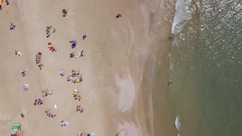 Mediterranean beach during summer with people in the water