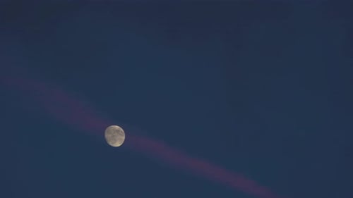 Pink Ribbon Cloud Floating by Waxing Gibbous Moon at Dusk