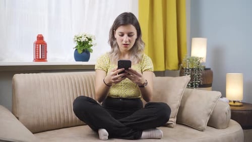 Young Woman Reacts to Bad News on Phone