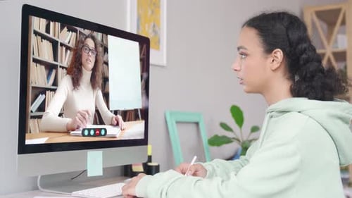 African school girl attends virtual lesson on computer during covid pandemic