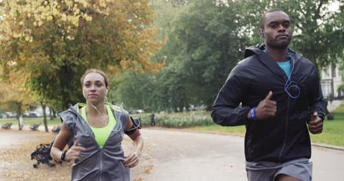 4k video footage of two friends jogging together in the park
