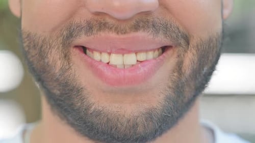 Young Woman Using Smart Watch while Sitting in Park