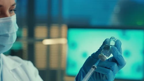 Healthcare Professional Draws Vaccine from Vial with Syringe