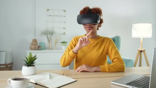 Woman Interacts in Virtual Reality at Bright Desk