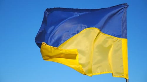 Ukrainian Flag Waving Against a Bright Blue Sky
