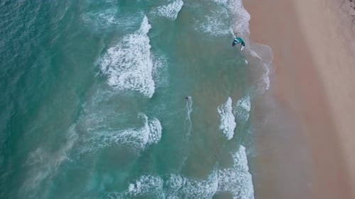 A Guy Rides on the Waves of Ocean on Kitesurfing