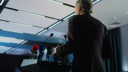 Male Press Officer Gives Interview in the Conference Hall