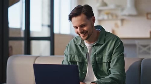 Young Adult Using Laptop Computer at Home