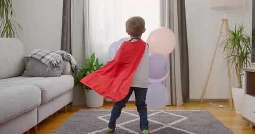 Playful Child Superhero with Balloons Celebrates Indoors
