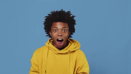 Young Adult Surprised and Smiling in Studio