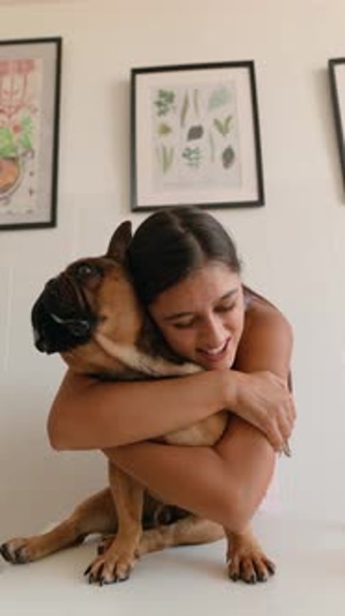 Young Woman Hugging her Cute French Bulldog