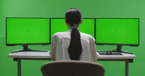 Asian Woman Having Video With Mock Up Multiple Computer Monitor In Green Screen Studio