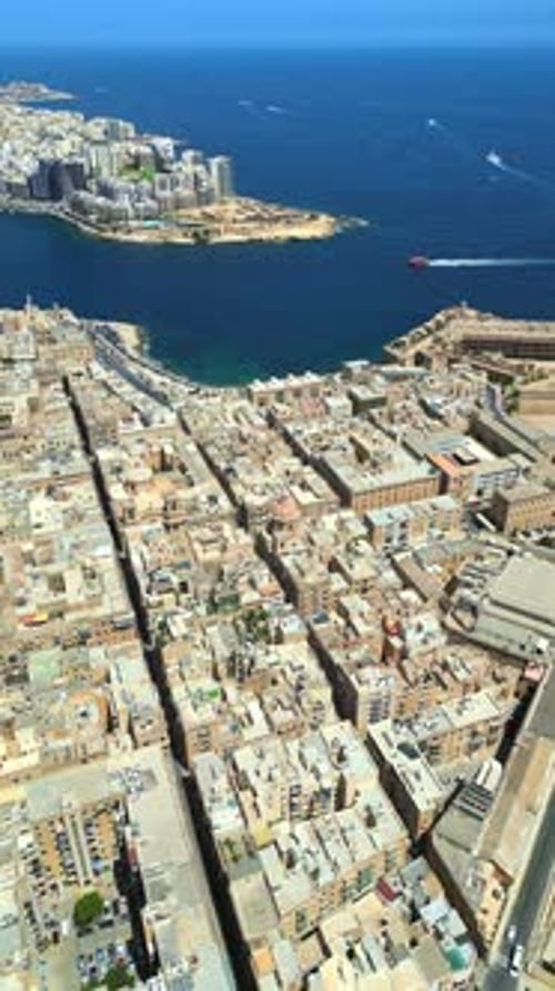 Aerial drone view of the walled city of Valletta, Malta, surrounded by the Mediterranean sea in dayl