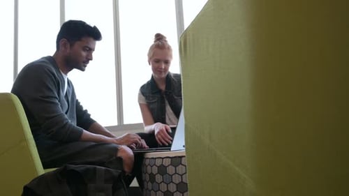 Students Sitting on Chairs Using Laptop in College Library 20s