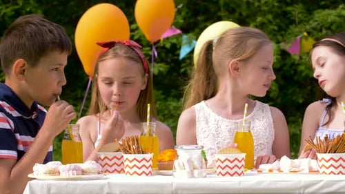 Children Enjoying Birthday Party with Drinks and Snacks