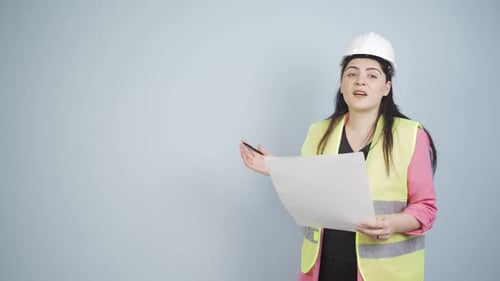 Engineer looking at camera in amazement and making a presentation.