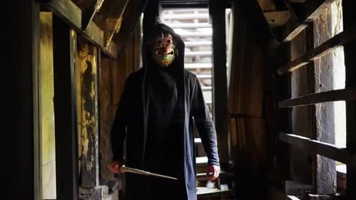 Cloaked Man Walking In Corridor Ruins