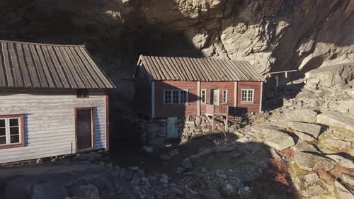 historical site with two old houses under cliff. Norway, drone footage