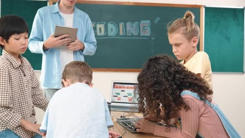 Children Coding Together in a Classroom with Teacher