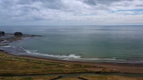 Tranquil Sea Bay with Foamy Waves Rolling on Empty Beach