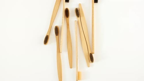 Collection of Wooden Toothbrushes on White Background